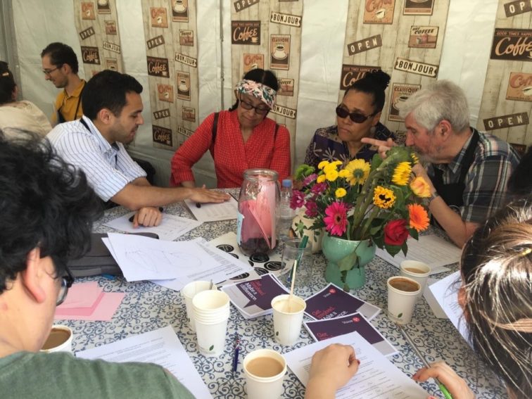 a group of patients having a discussion around a table with a clinician