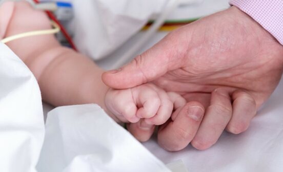 Clinicianholdingbabyshand